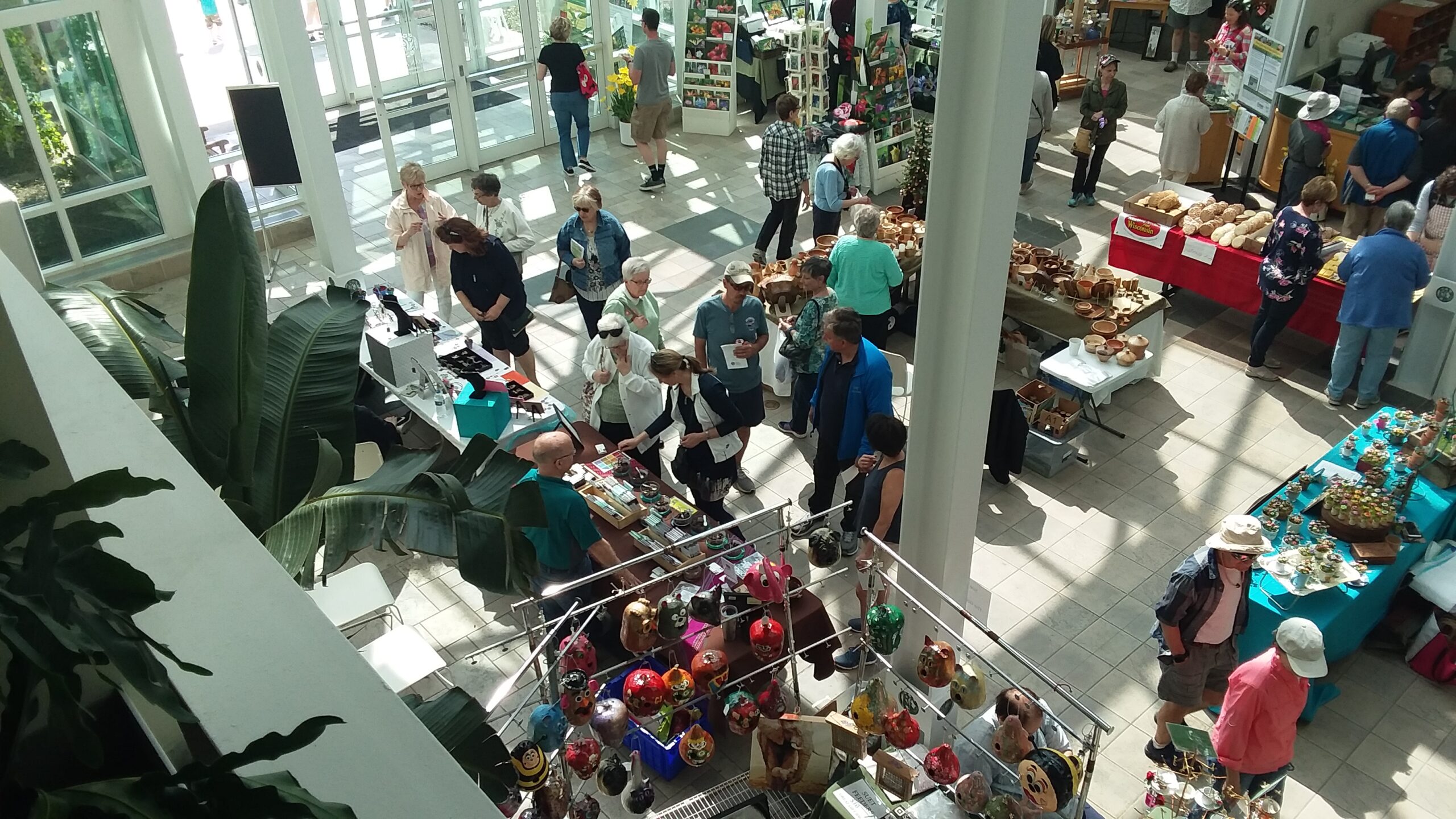Three photos of children with their parents doing crafts at Boerner Botanical Gardens.