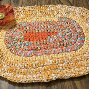 A photo of a rag rug placemat on a table.
